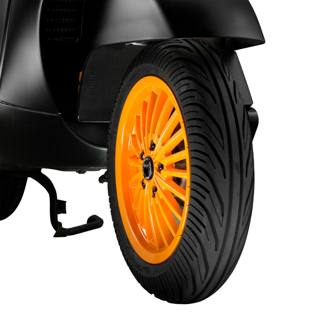 A black tyre with an orange rim