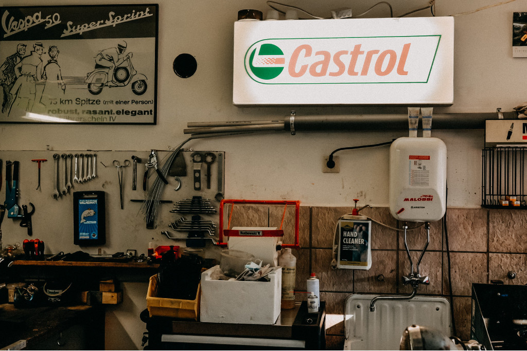 Wall with tools and advertising signs in a Vespa workshop