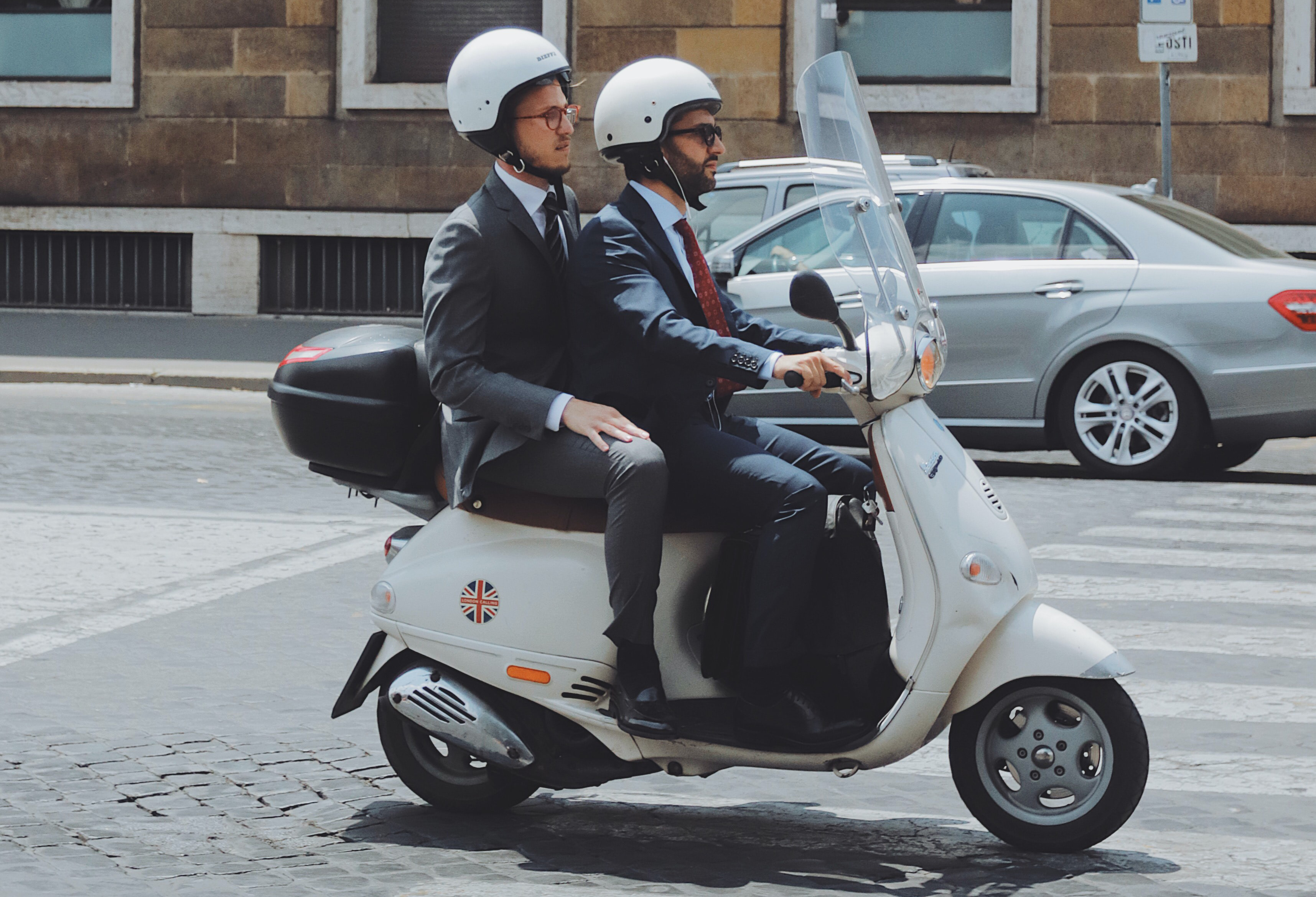 Two men sitting on a vespa