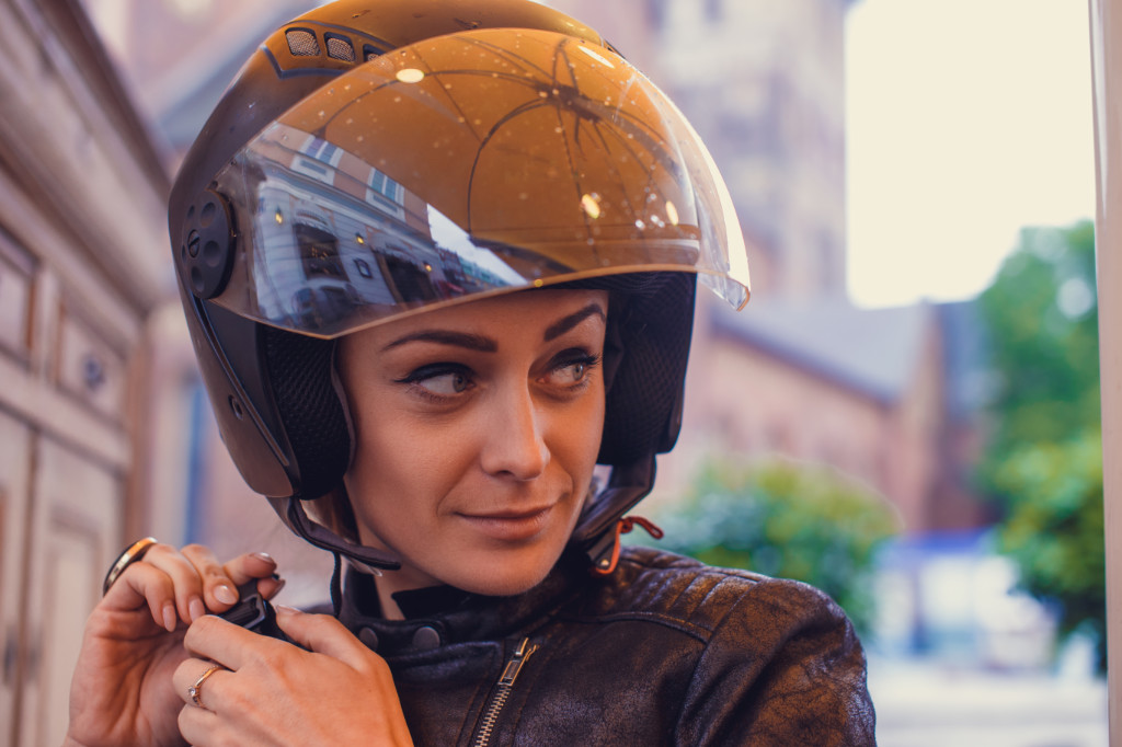 a woman in a moto helmet.